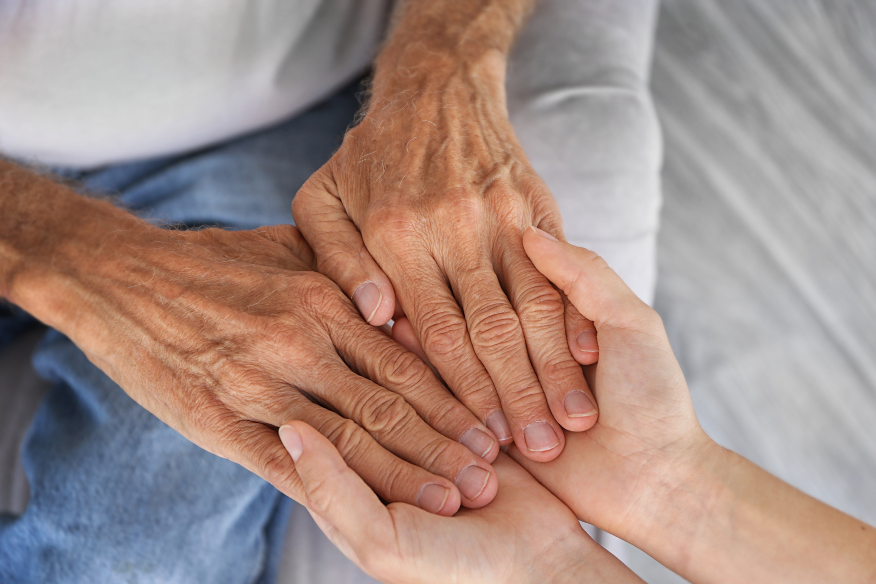 Young Person Holding Old Person Hand 